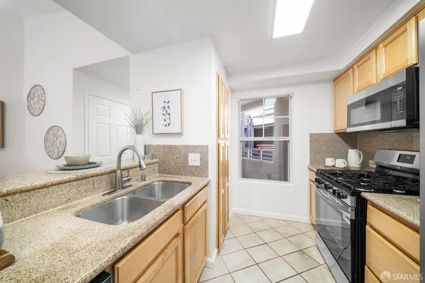 a kitchen with stainless steel appliances granite countertop a stove a refrigerator and a microwave