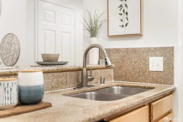 a kitchen with stainless steel appliances granite countertop a refrigerator and a stove