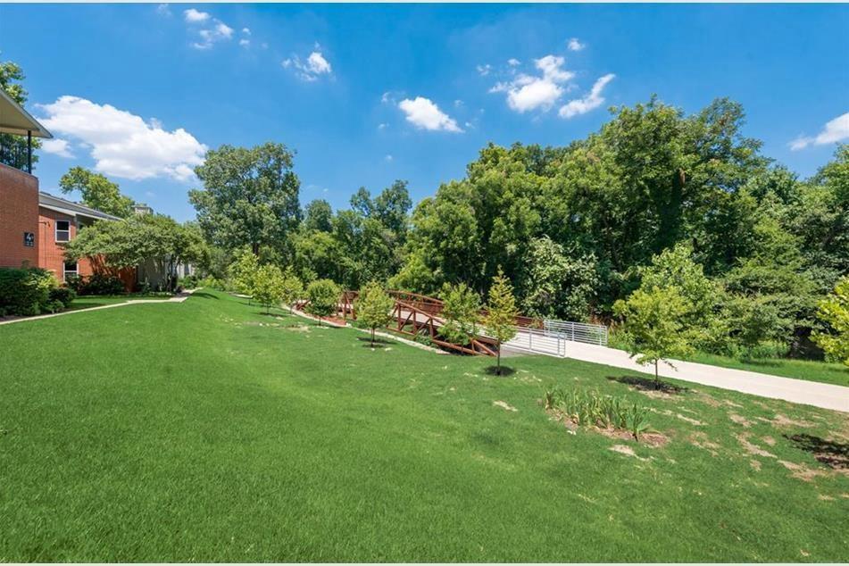 6900 Skillman Street, Unit 101 Dallas, TX 75231 - Photo 13 of 13 a view of a golf course with a lake