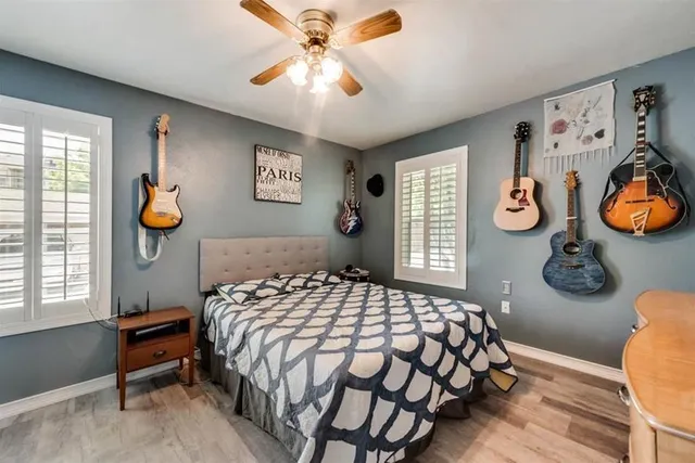 a bedroom with a bed and painting on the wall