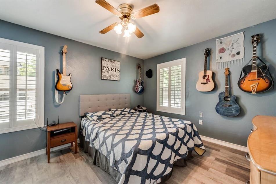 6900 Skillman Street, Unit 101 Dallas, TX 75231 - Photo 2 of 13 a bedroom with a bed and painting on the wall