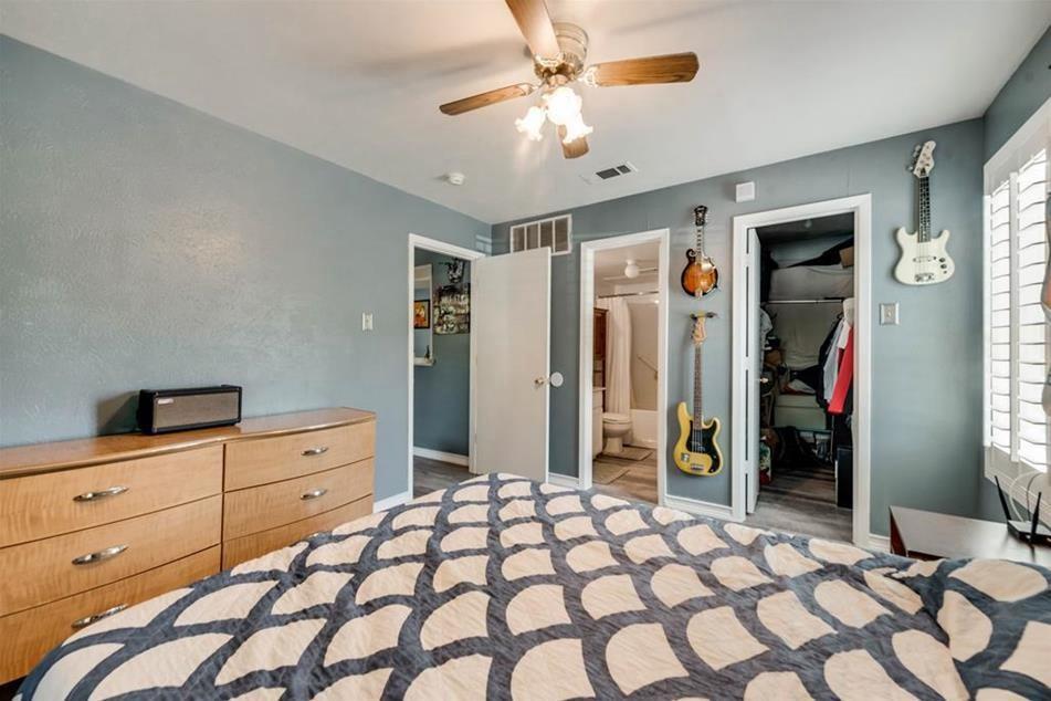6900 Skillman Street, Unit 101 Dallas, TX 75231 - Photo 3 of 13 a bedroom with a dresser and a chandelier