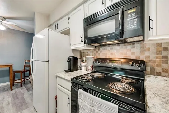 a stove top oven sitting inside of a kitchen