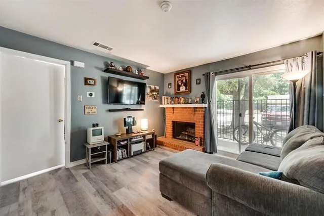 a living room with fireplace furniture and a flat screen tv