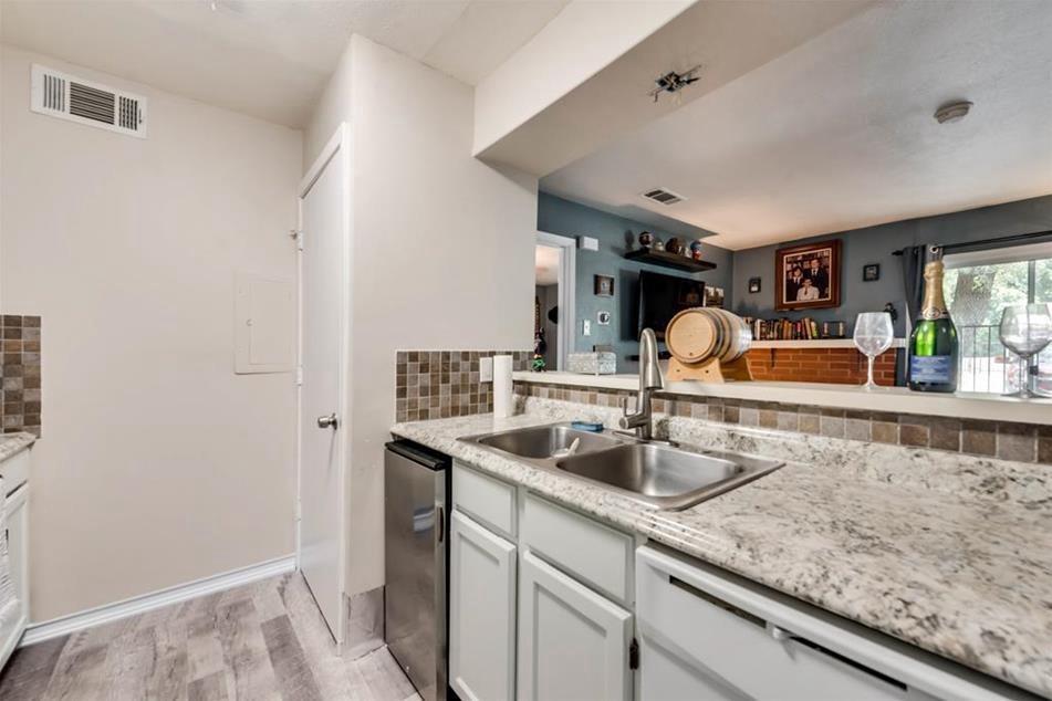 6900 Skillman Street, Unit 101 Dallas, TX 75231 - Photo 8 of 13 a kitchen with sink and mirror