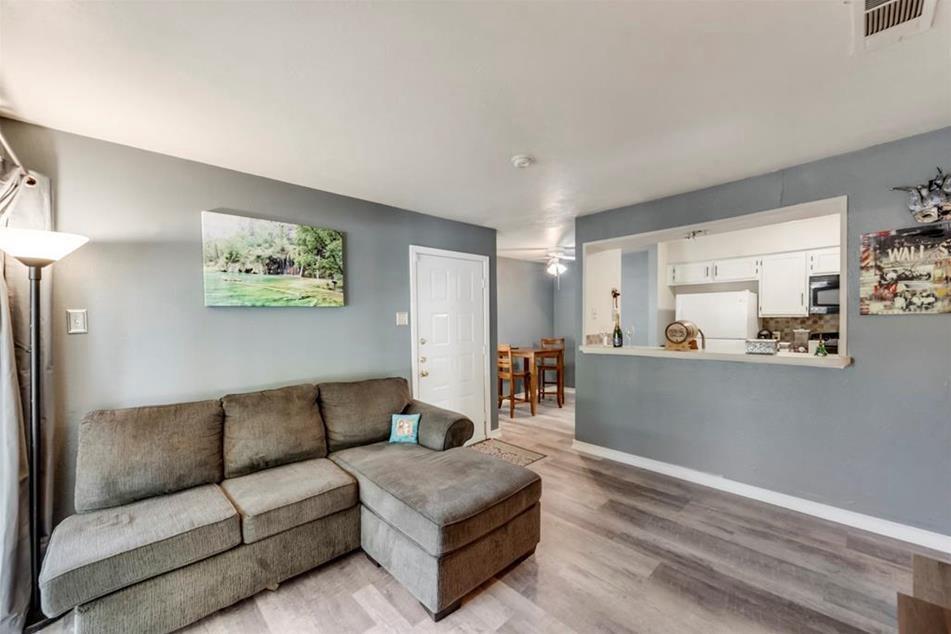 6900 Skillman Street, Unit 101 Dallas, TX 75231 - Photo 9 of 13 a living room with furniture and a view of kitchen