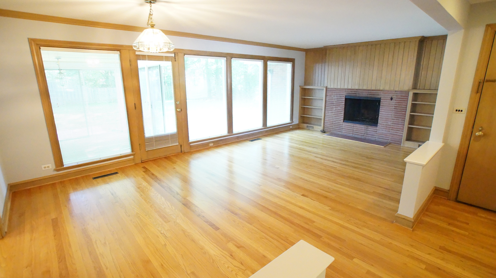459 Highcrest Drive Wilmette, IL 60091 - Photo 3 of 26 a view of an empty room with wooden floor and a window