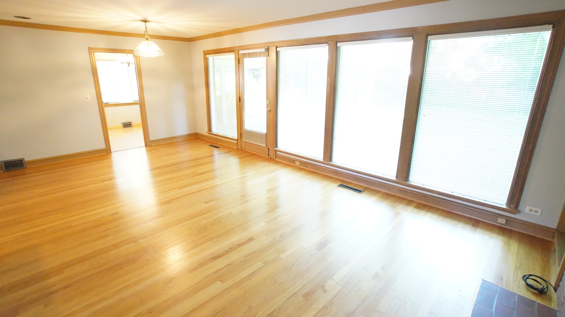 459 Highcrest Drive Wilmette, IL 60091 - Photo 6 of 26 a view of an empty room with wooden floor and a window