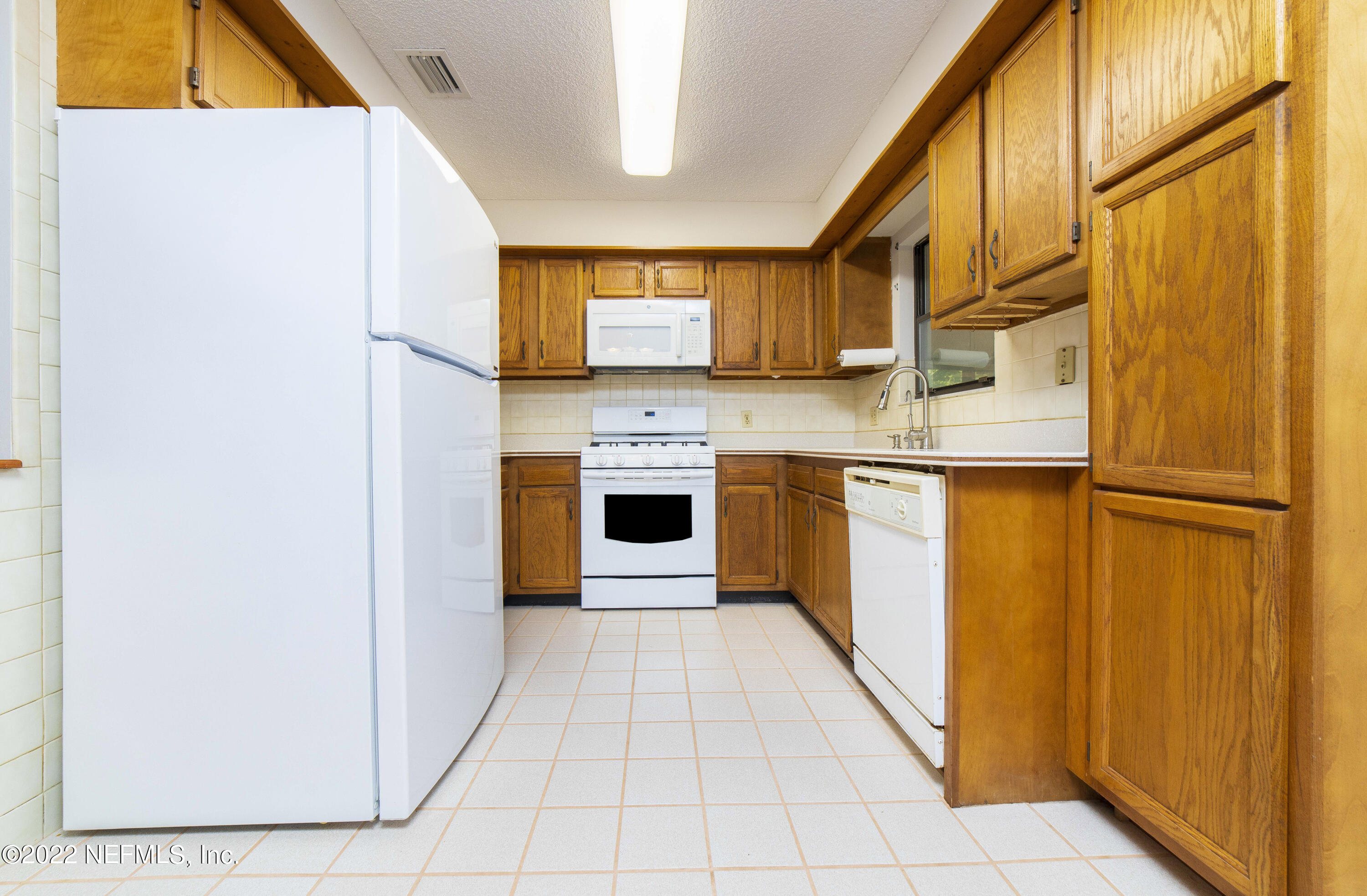 138 Drake Road St. Augustine, FL 32086 - Photo 10 of 46 a kitchen with stainless steel appliances granite countertop a refrigerator a stove and a sink