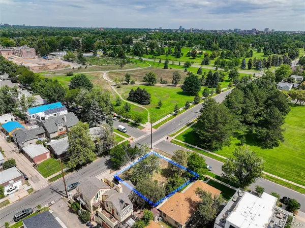 an aerial view of a house with a yard and lake view