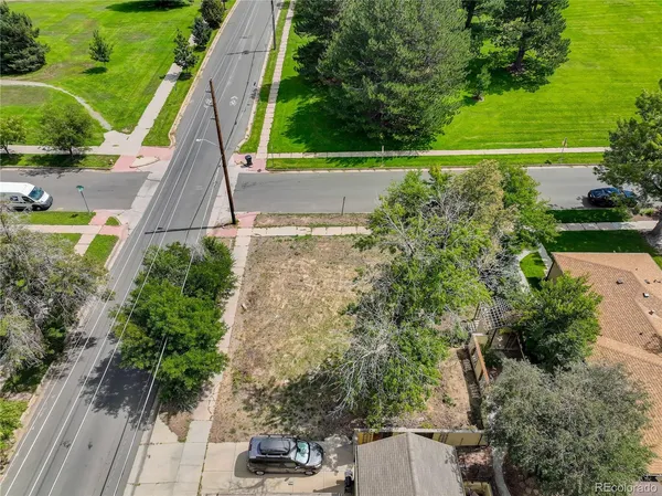 an aerial view of a house with a yard and lake view