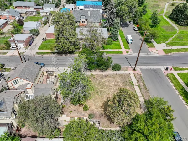 an aerial view of a house with a yard and potted plants