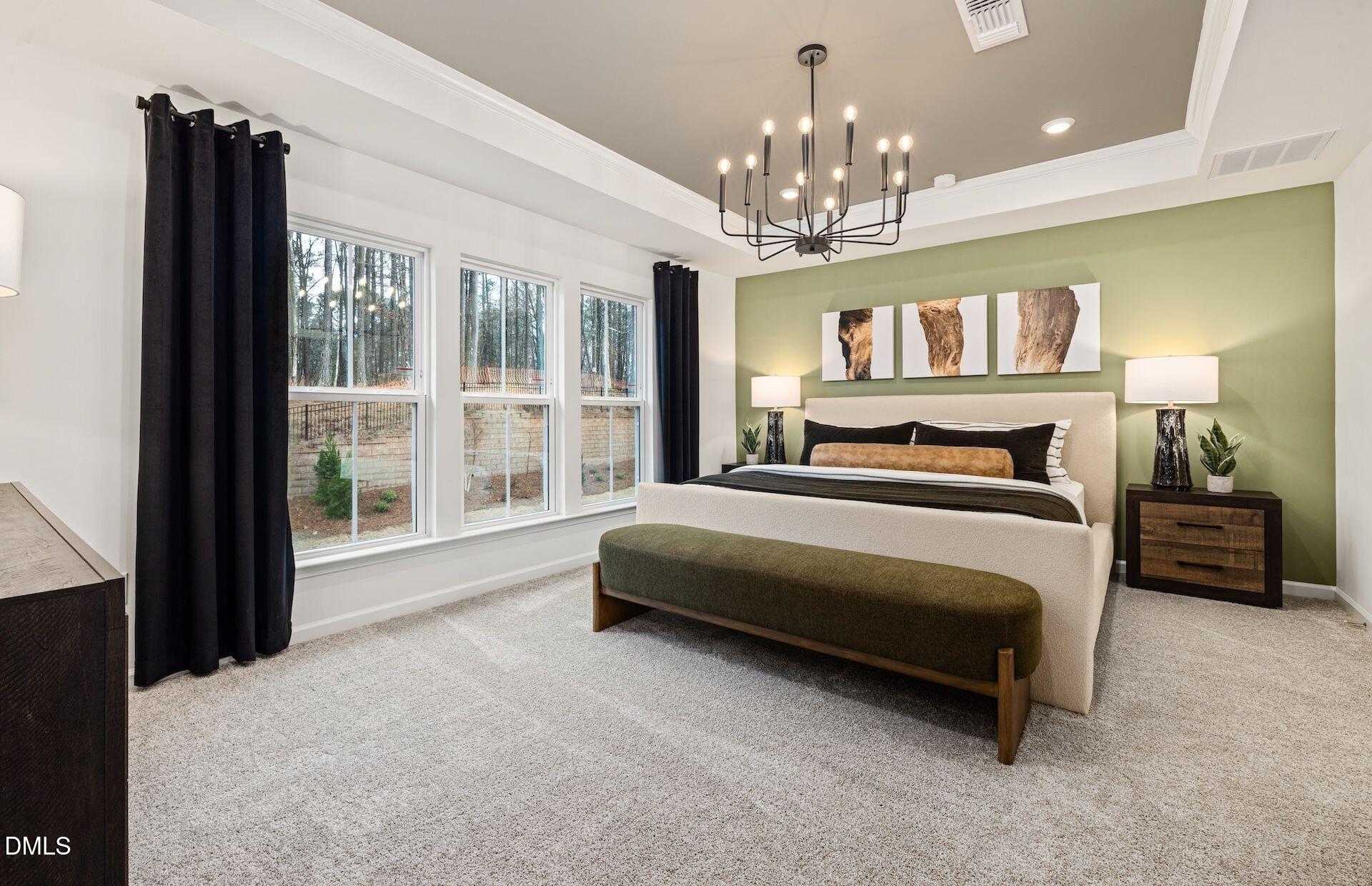 5020 Reader Way Durham, NC 27703 - Photo 10 of 32 a bedroom with a large bed a chandelier and windows