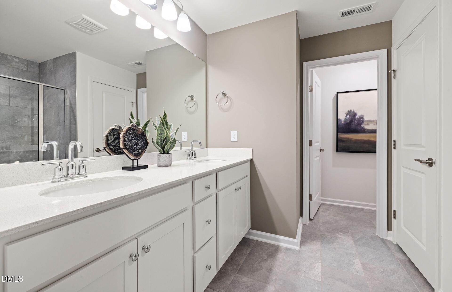 5020 Reader Way Durham, NC 27703 - Photo 12 of 32 a en suite bathroom with a double vanity sink and mirror