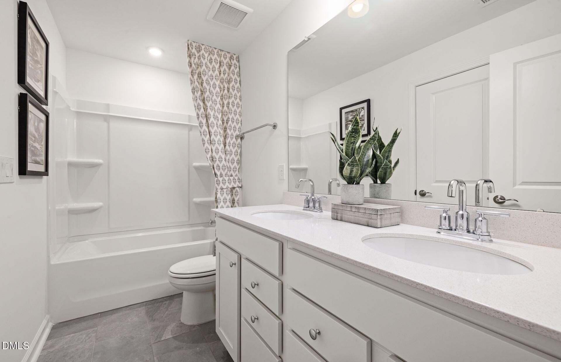 5020 Reader Way Durham, NC 27703 - Photo 17 of 32 a bathroom with a double vanity sink toilet and shower