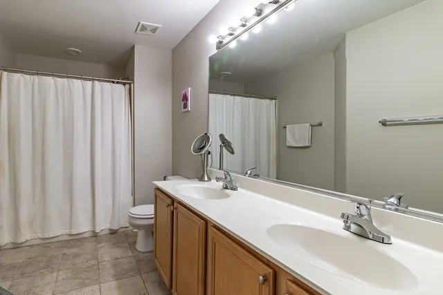a bathroom with a double vanity sink and a mirror