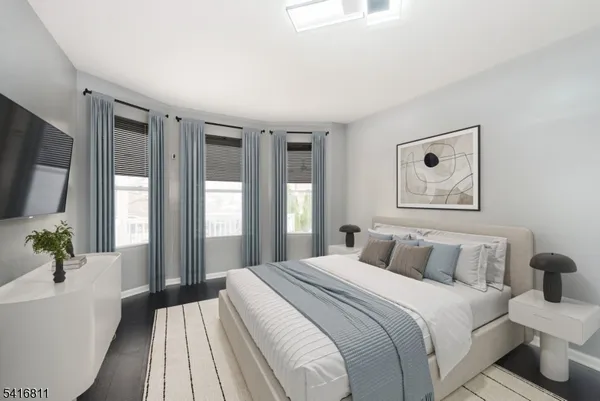 a bedroom with a large bed and a large window