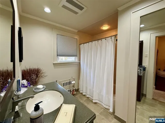 a bathroom with a sink mirror and vanity