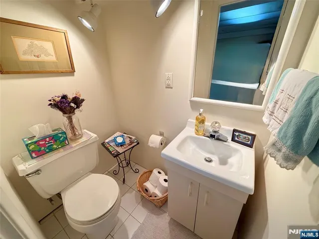 a bathroom with a sink mirror and toilet