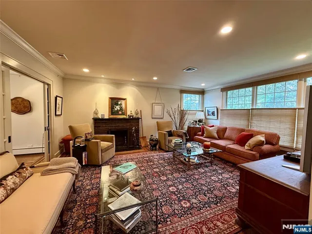 a living room with furniture a rug and a large window