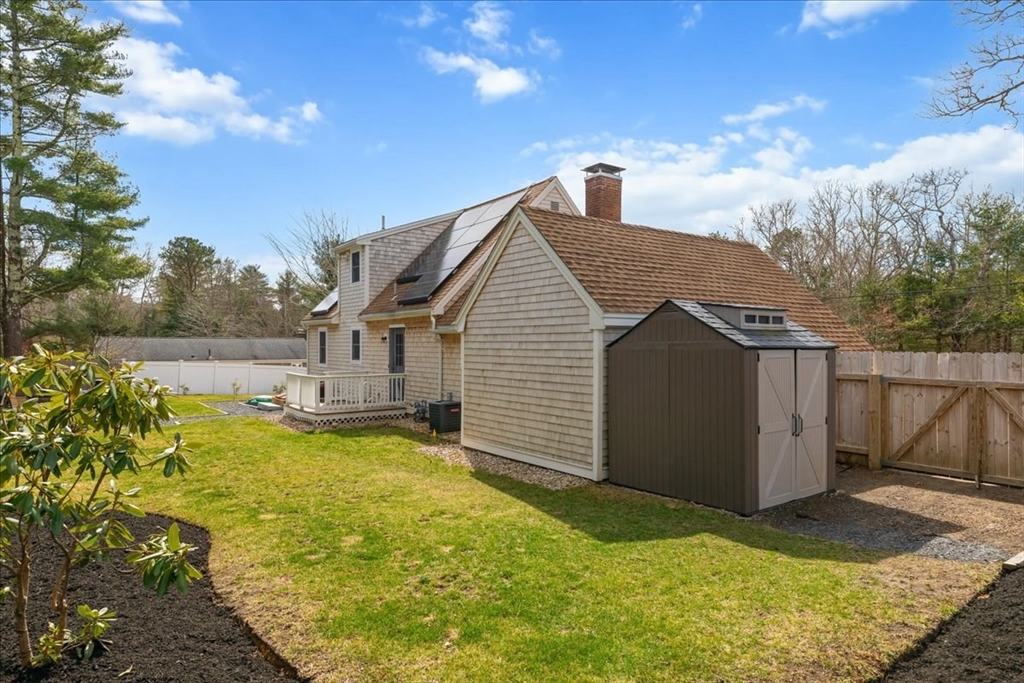 299 Cotuit Road Mashpee, MA 02649 - Photo 27 of 33 a view of a house with a yard