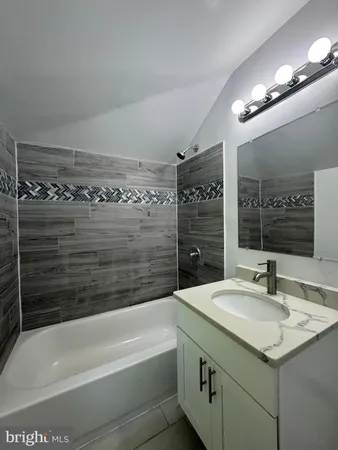 a bathroom with a bathtub and a sink