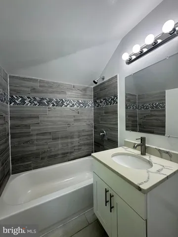 a bathroom with a bathtub and a sink