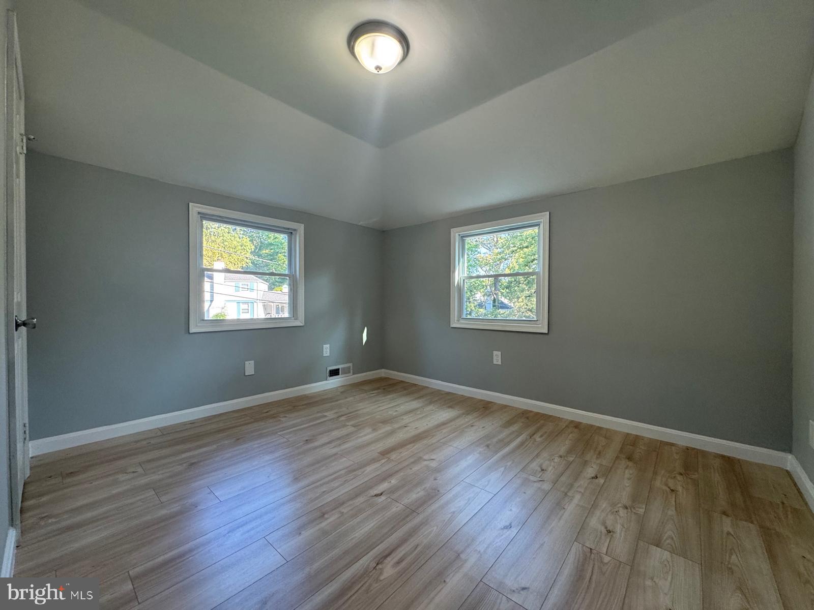 5735 Euclid Street Landover, MD 20785 - Photo 10 of 14 a view of an empty room with wooden floor and a window