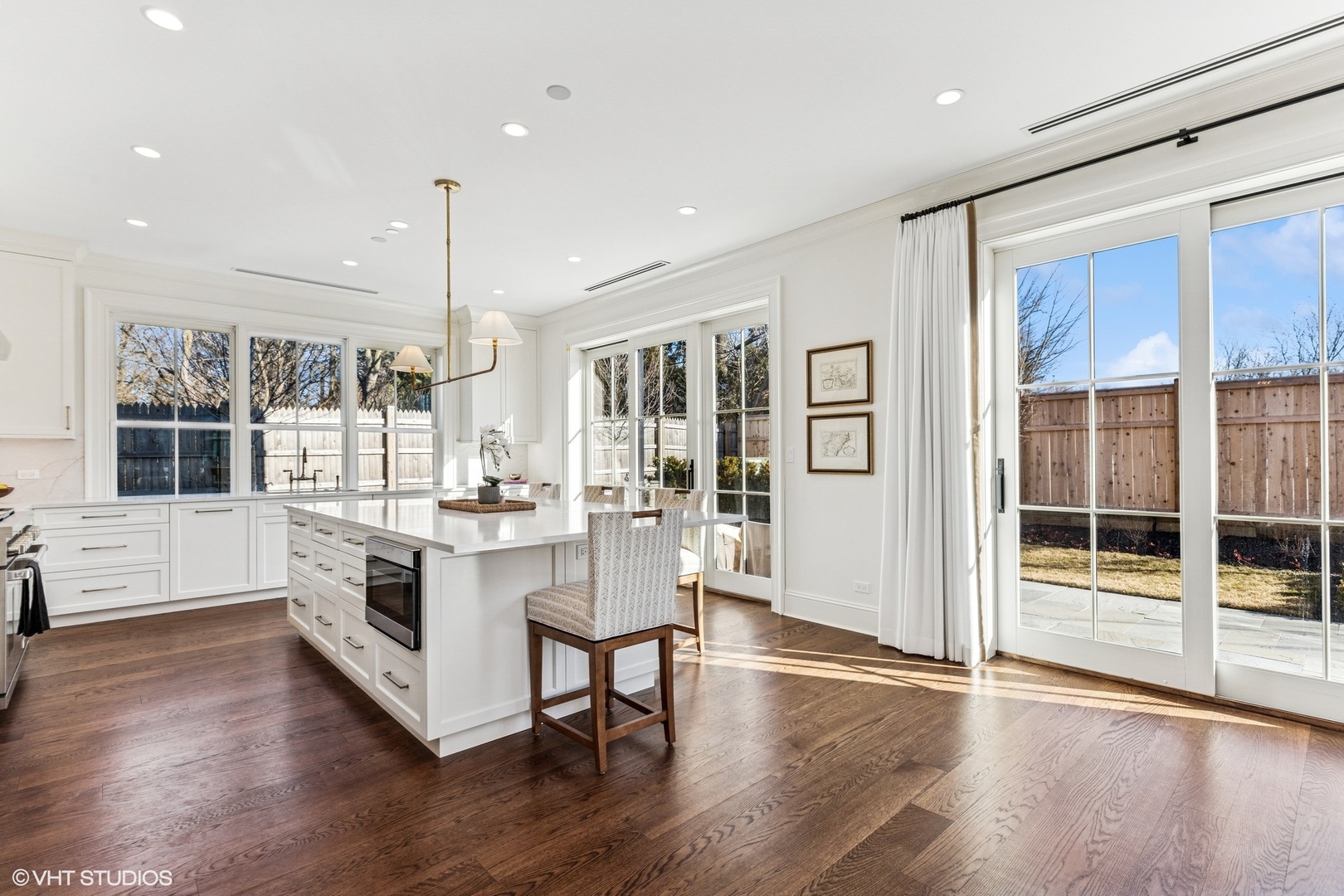 120 East Scranton Avenue, Unit 202 Lake Bluff, IL 60044 - Photo 4 of 15 a large white kitchen with granite countertop a stove top oven a sink a dining table and chairs