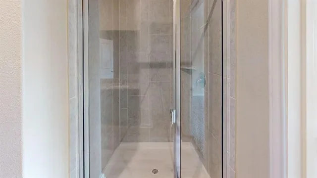 a bathroom with a glass shower door