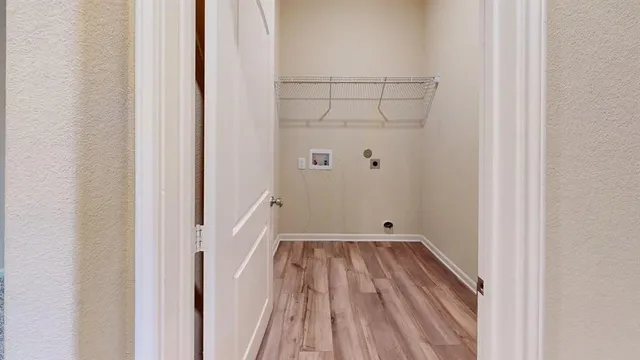 a view of a room with wooden floor