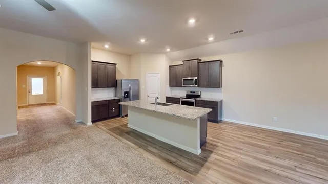 a view of a chandelier fan and windows
