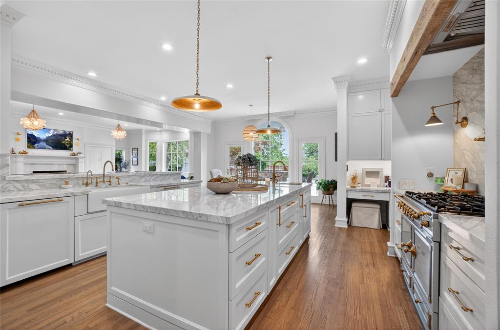 6331 Waggoner Drive Dallas, TX 75230 - Photo 12 of 36 a kitchen with stainless steel appliances granite countertop a sink a stove and a wooden floors