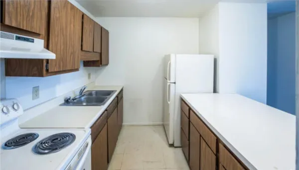 a kitchen with a sink a stove and cabinets