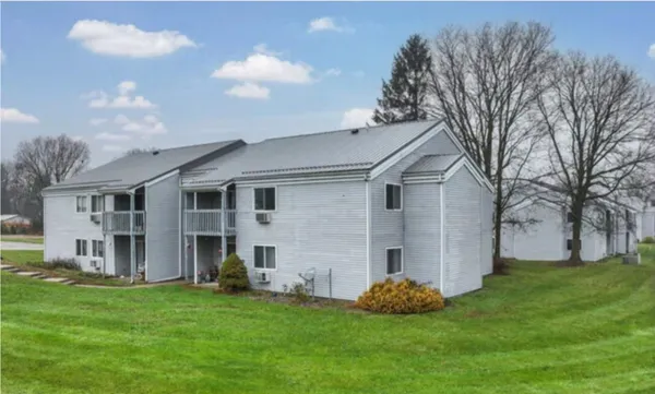 a backyard of a house with table and chairs