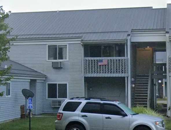 a front view of a house with parking space