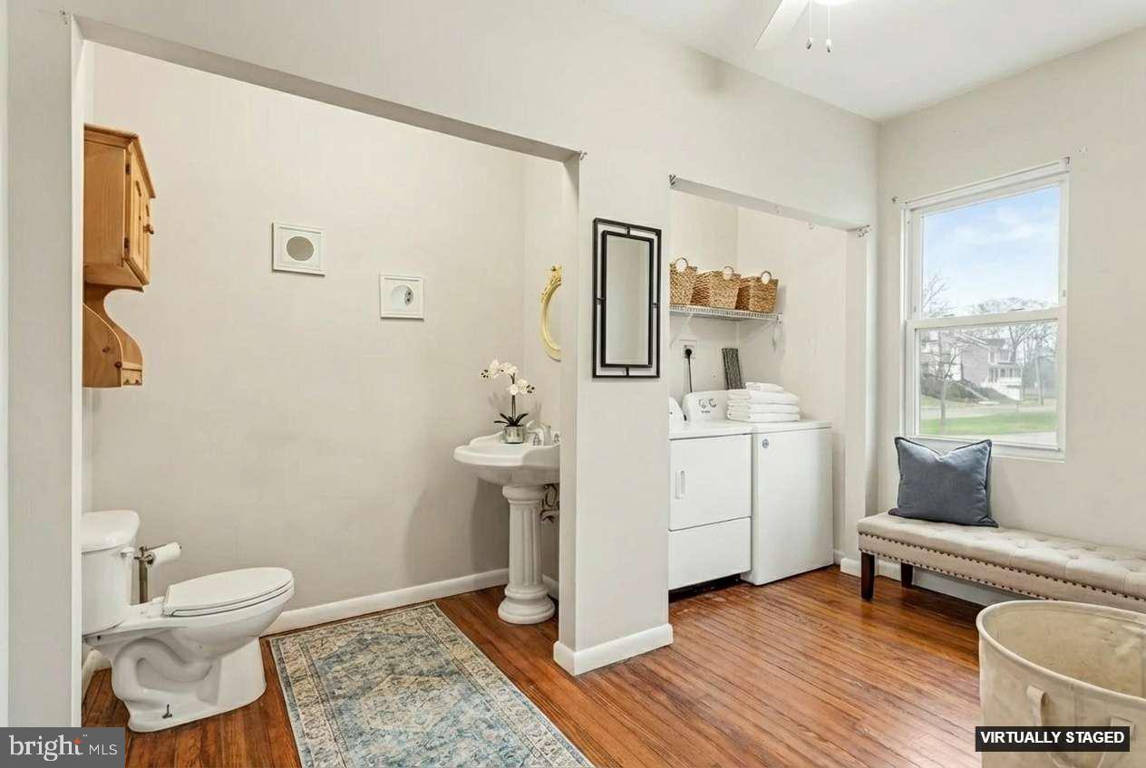 2810 & 2810-a 12th Street Baltimore, MD 21219 - Photo 11 of 67 a bathroom with a toilet a sink and a mirror