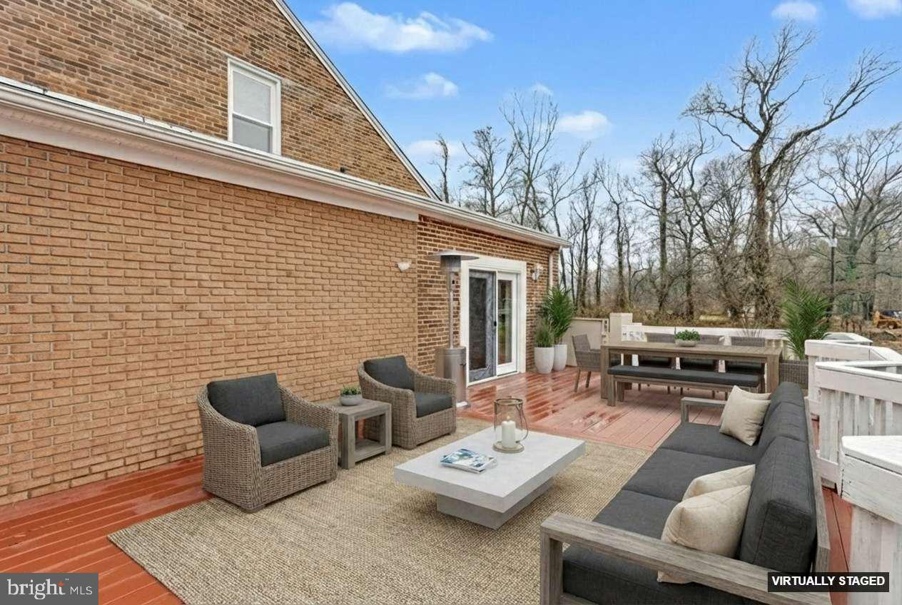 2810 & 2810-a 12th Street Baltimore, MD 21219 - Photo 16 of 67 a view of a patio with couches table and chairs with wooden floor and fence