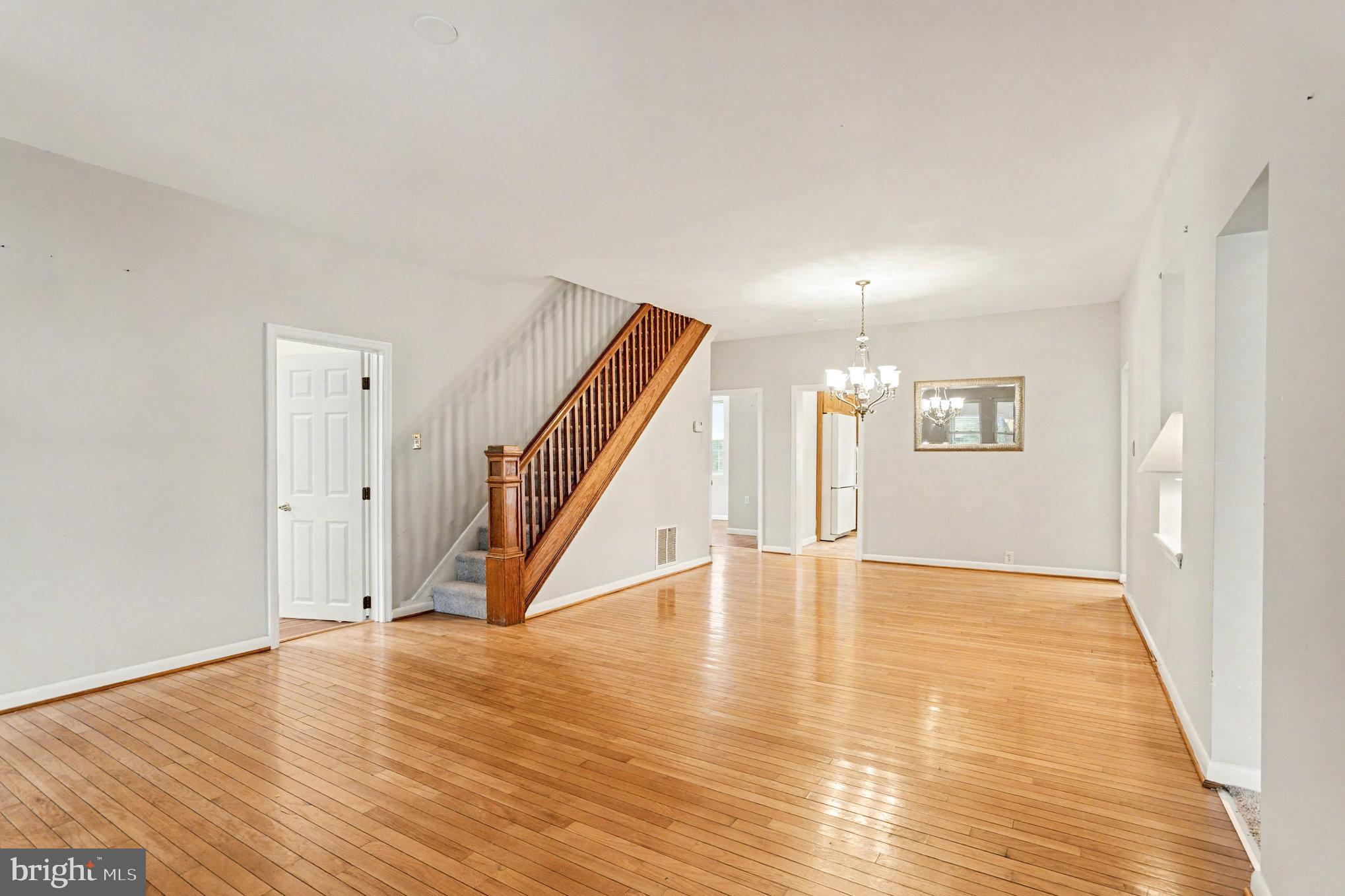 2810 & 2810-a 12th Street Baltimore, MD 21219 - Photo 19 of 67 a view of an empty room with wooden floor and stairs