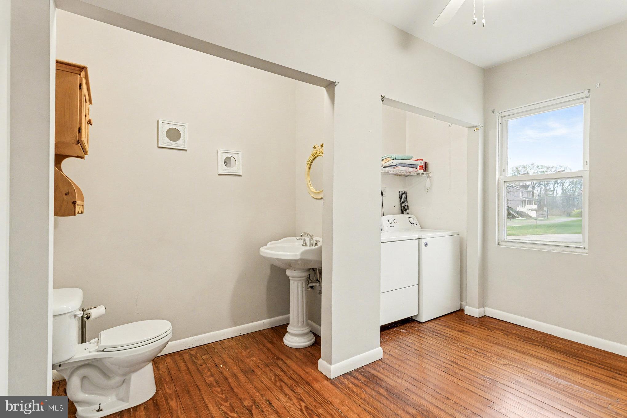2810 & 2810-a 12th Street Baltimore, MD 21219 - Photo 27 of 67 a bathroom with a sink a toilet and a window