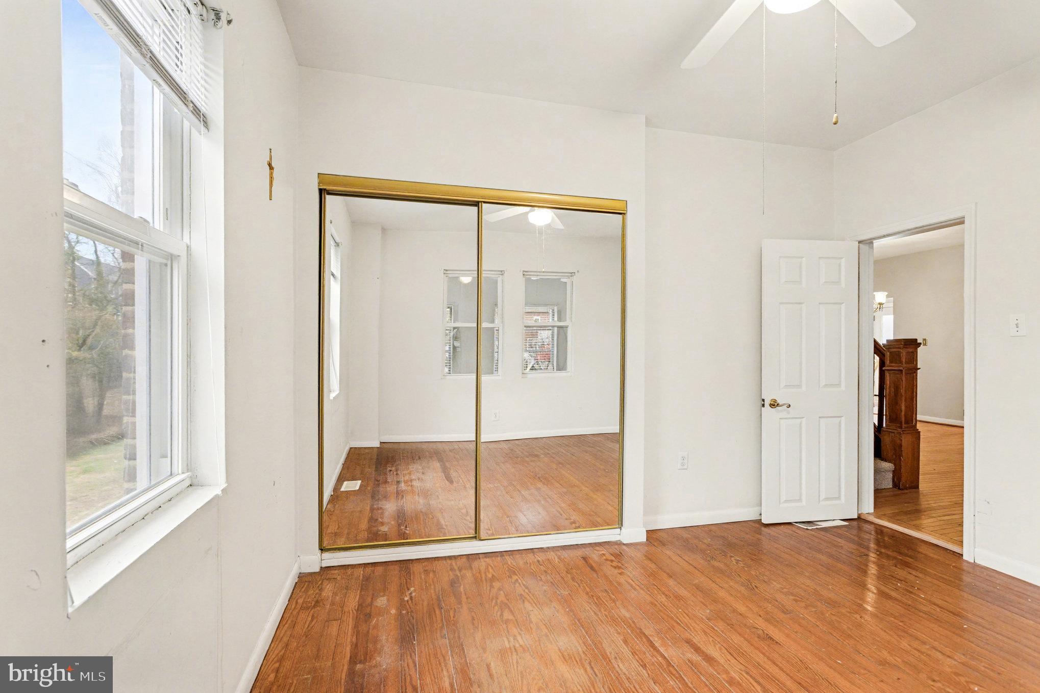 2810 & 2810-a 12th Street Baltimore, MD 21219 - Photo 33 of 67 a view of an empty room with wooden floor and a window