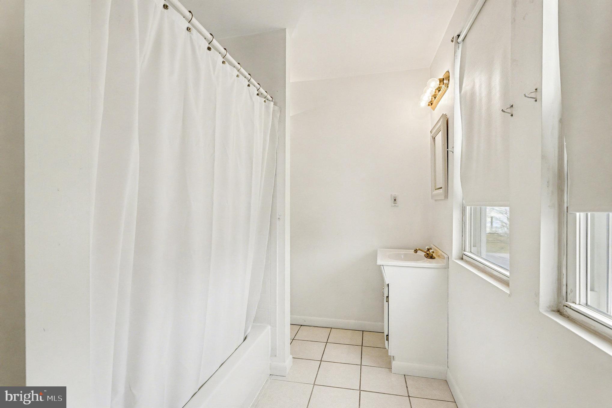 2810 & 2810-a 12th Street Baltimore, MD 21219 - Photo 34 of 67 a bathroom with a shower and a sink