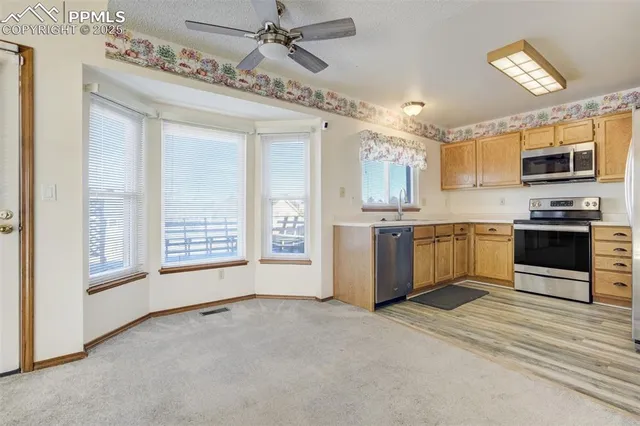 a kitchen with stainless steel appliances a stove microwave and sink