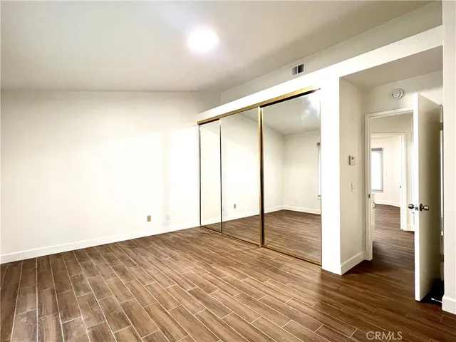 a view of an empty room and wooden floor