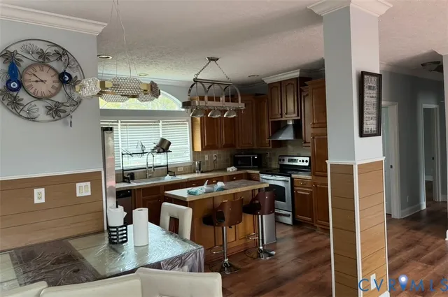 a kitchen with stainless steel appliances granite countertop a sink and a refrigerator