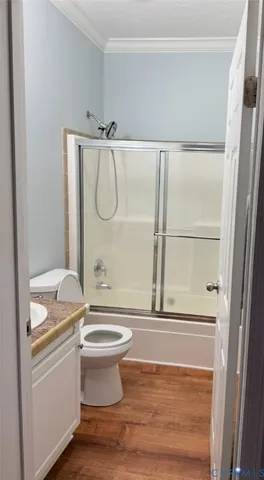 a bathroom with a granite countertop sink a toilet and shower