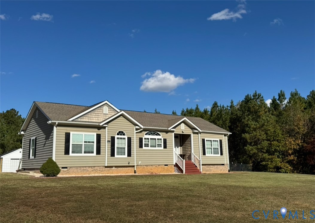 12232 Cedar Lane Ashland, VA 23005 - Photo 2 of 18 a front view of a house with a yard and garage