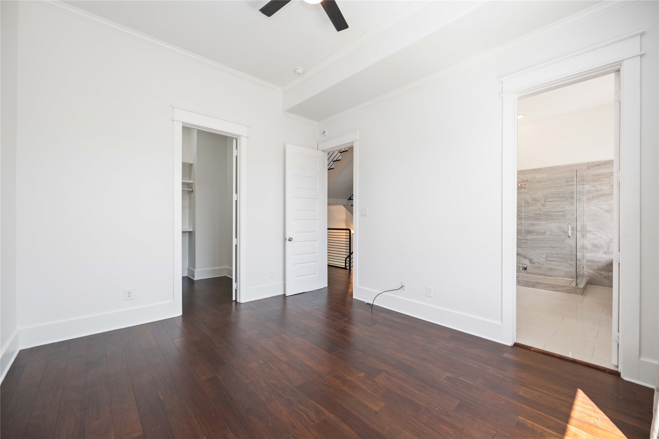 2211 Detering Street, Unit B Houston, TX 77007 - Photo 14 of 22 The Primary Bedroom features dark engineered wood floors. It boasts a large walk-in closet and an adjoining primary bathroom with a modern glass shower.
