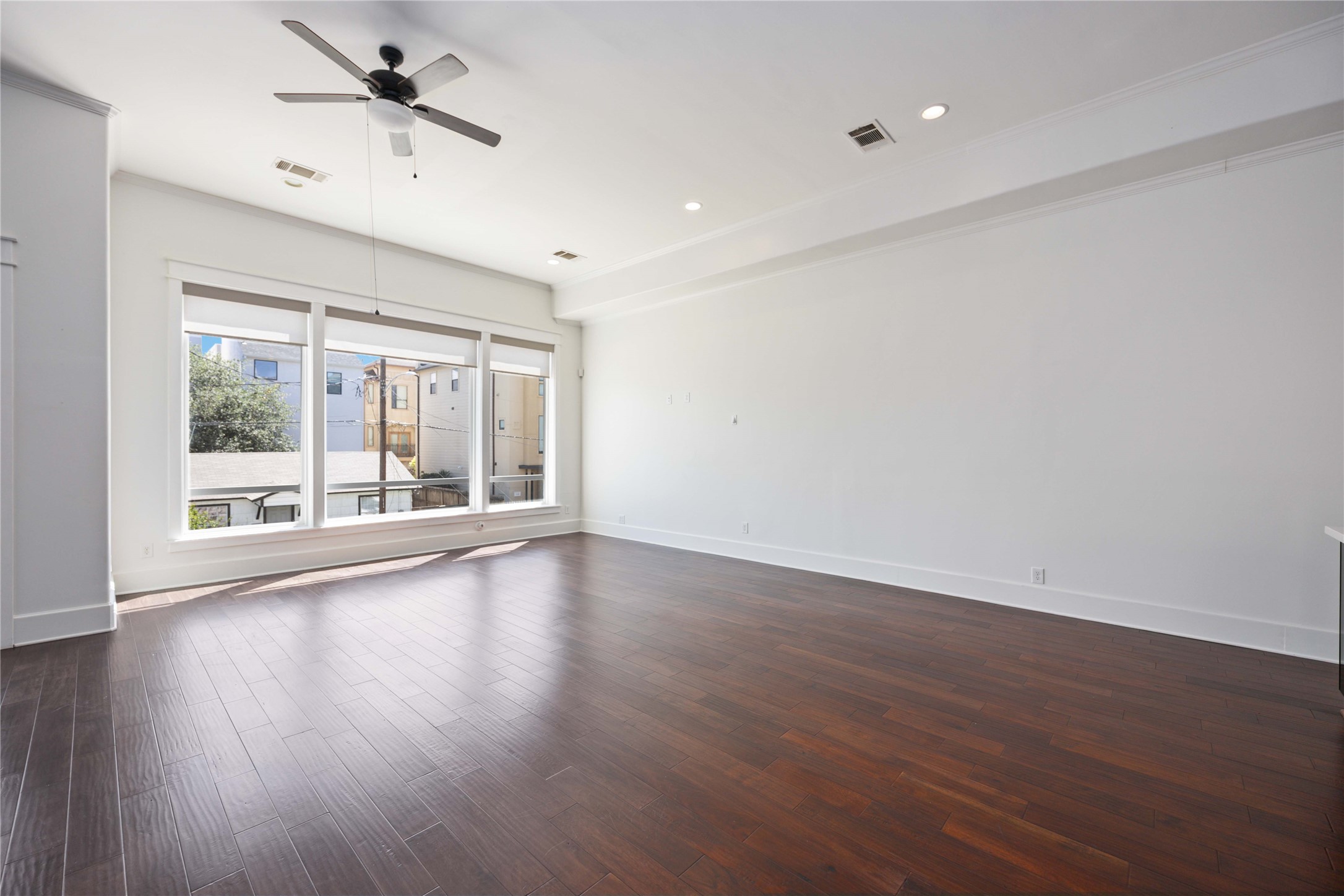 2211 Detering Street, Unit B Houston, TX 77007 - Photo 6 of 22 Spacious Living Area with Large Windows for Ample Natural Light, andDark Engineered Wood Floors. Ideal for comfortable living and entertaining.