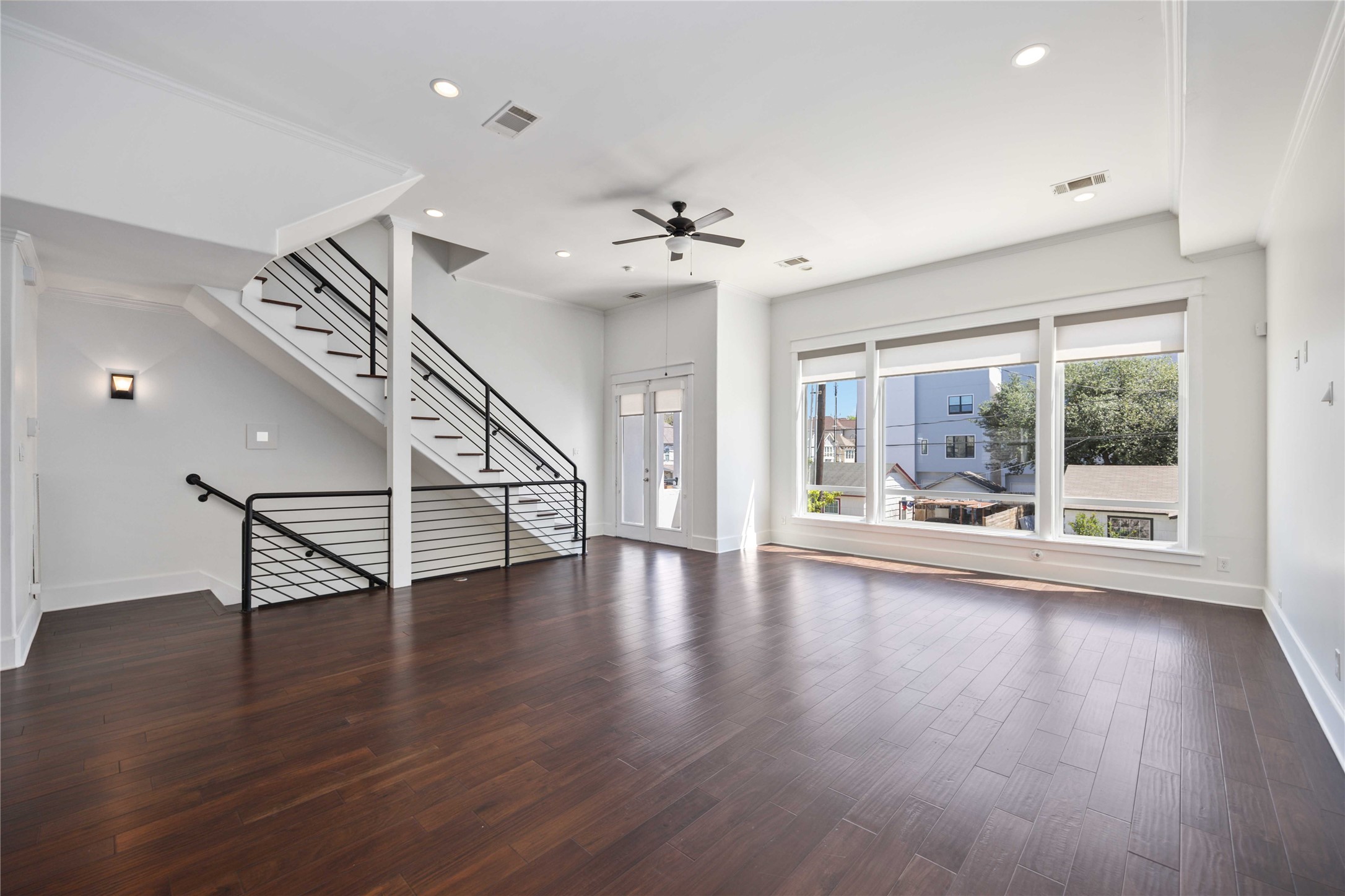 2211 Detering Street, Unit B Houston, TX 77007 - Photo 7 of 22 Spacious living area featuring a stunning wall of windows that floods the room with abundant natural light.